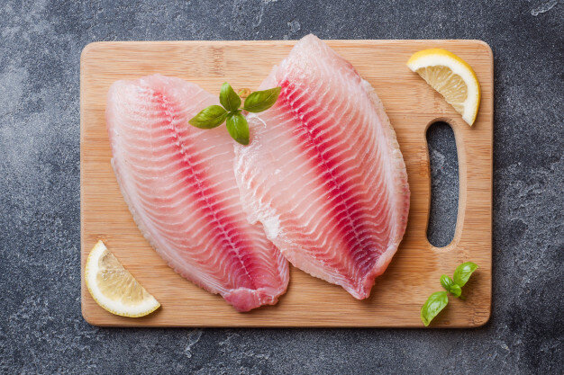 raw-fish-fillet-tilapia-cutting-board-with-lemon-spices-dark-table_78677-2404.jpg